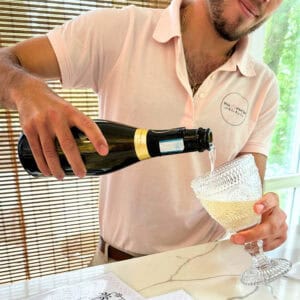 Server pouring champagne at the Wink and Wave Spa at Bala Bay Inn