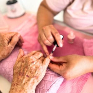 Manicure being done on elderly hand at the Wink and Wave Spa at Bala Bay Inn