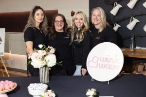 4 women in front of event table
