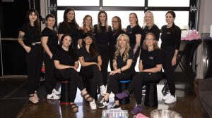 A group of women at an event all in black shirts